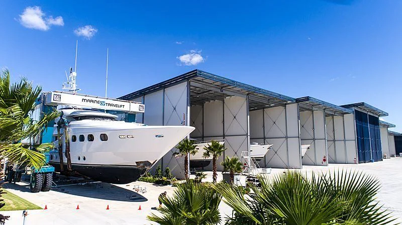 a large white boat in front of a building aboard DE LISLE III Yacht for Sale
