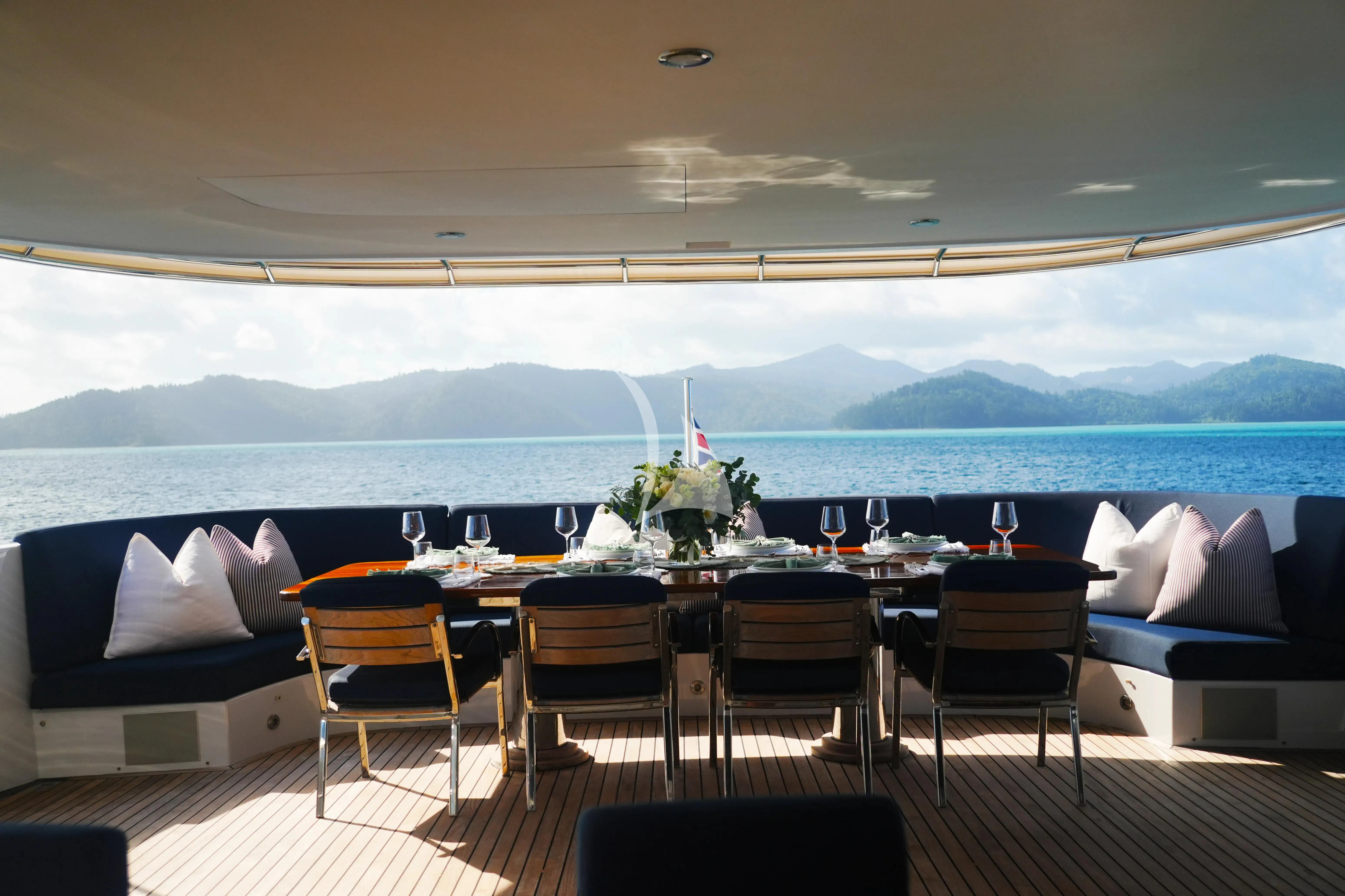a room with a table and chairs aboard DE LISLE III Yacht for Sale