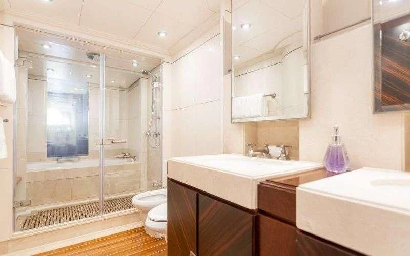 a bathroom with a glass shower aboard DE LISLE III Yacht for Sale