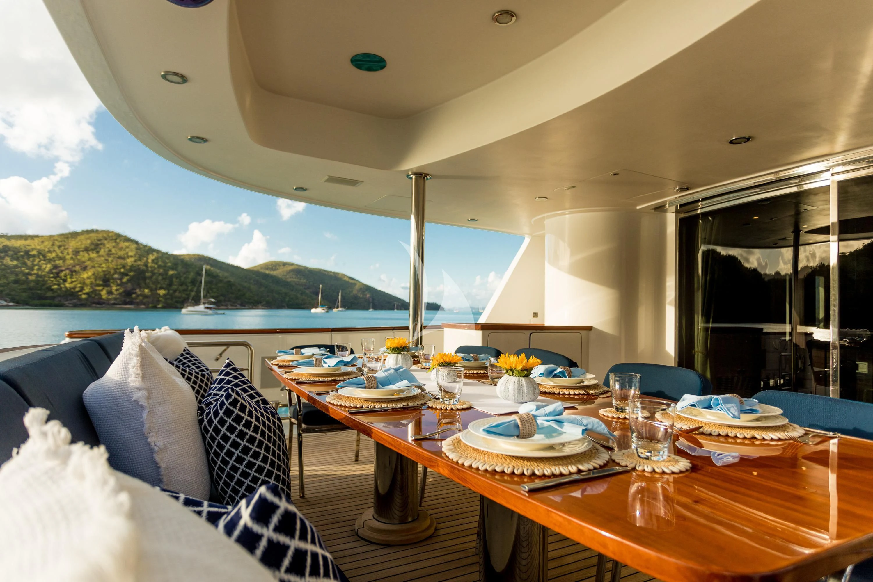 a table with plates and glasses on it aboard DE LISLE III Yacht for Sale