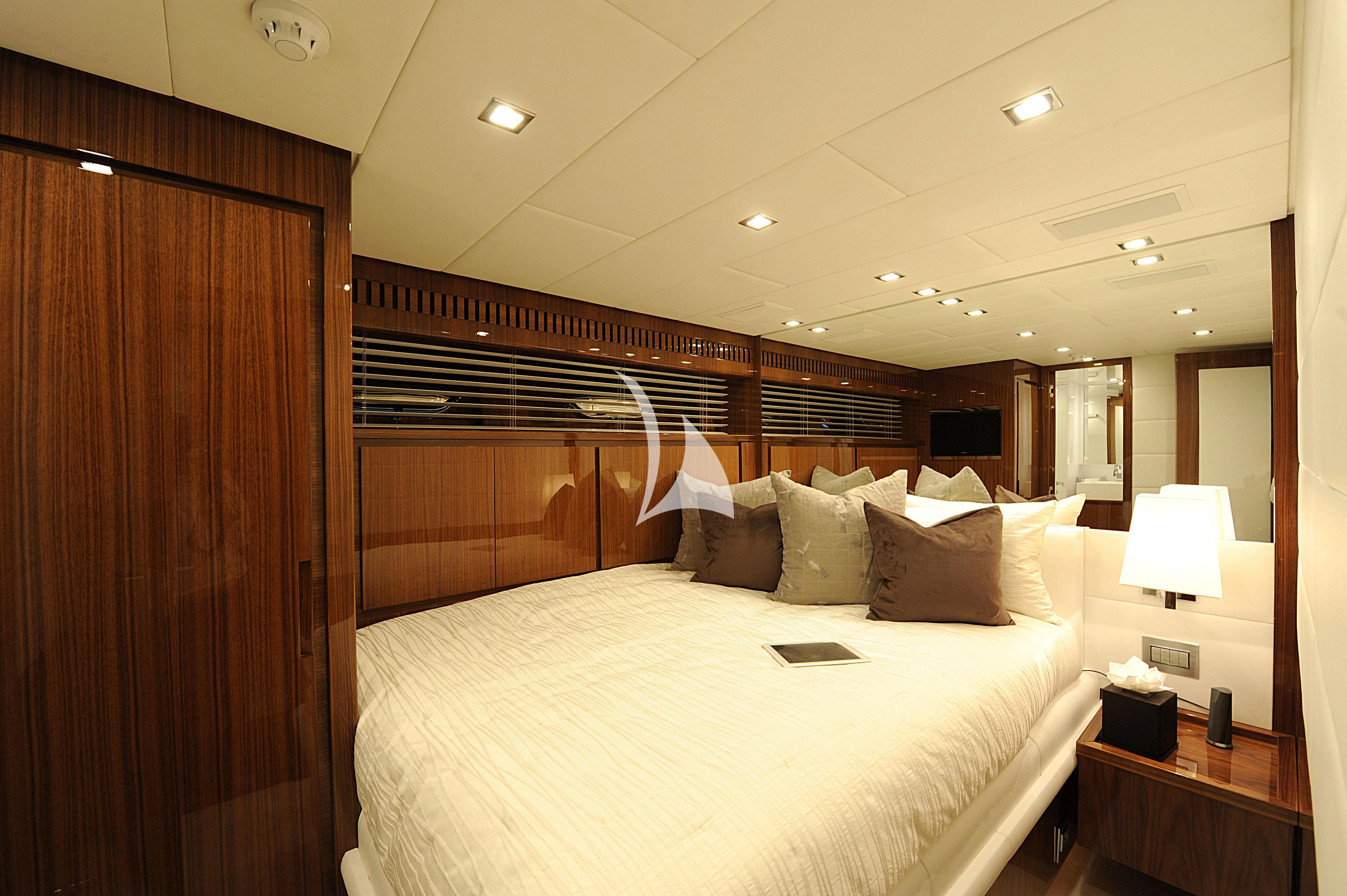 a bed with a white bed spread aboard PHOENICIAN Yacht for Sale