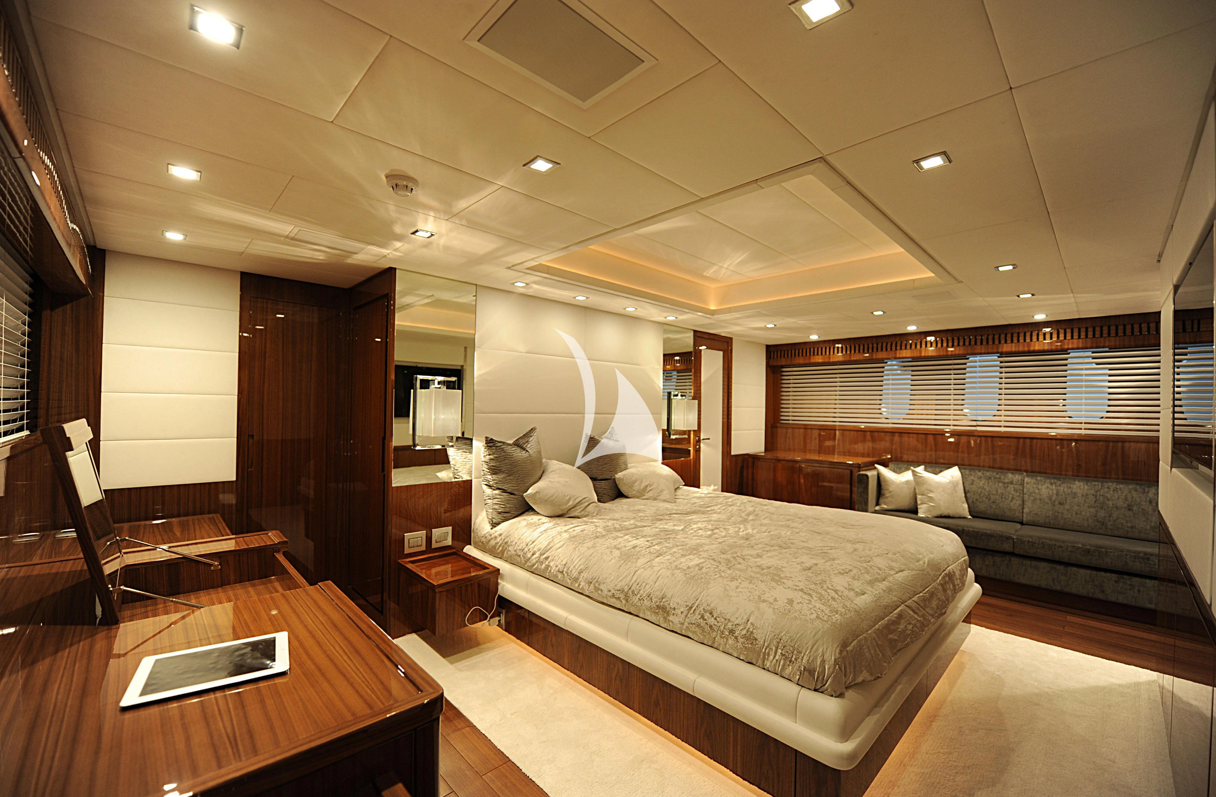 a large bedroom with a bed and a couch aboard PHOENICIAN Yacht for Sale