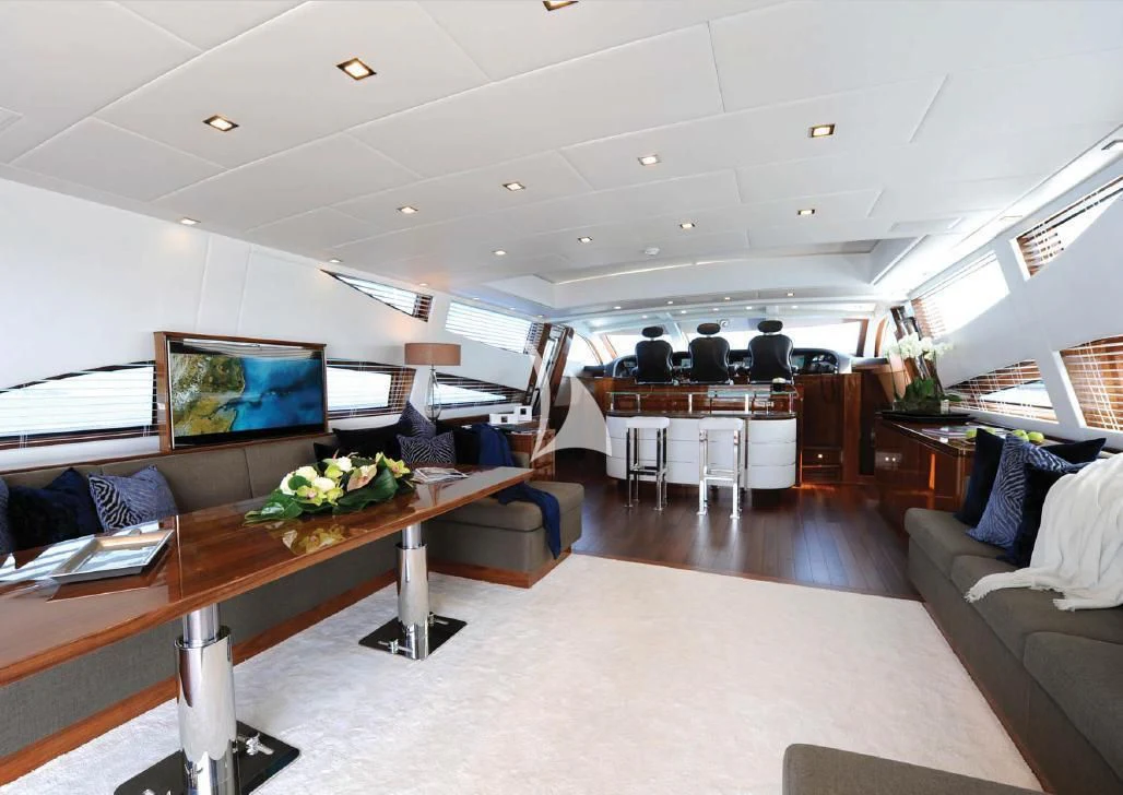 a large room with a table and chairs aboard PHOENICIAN Yacht for Sale