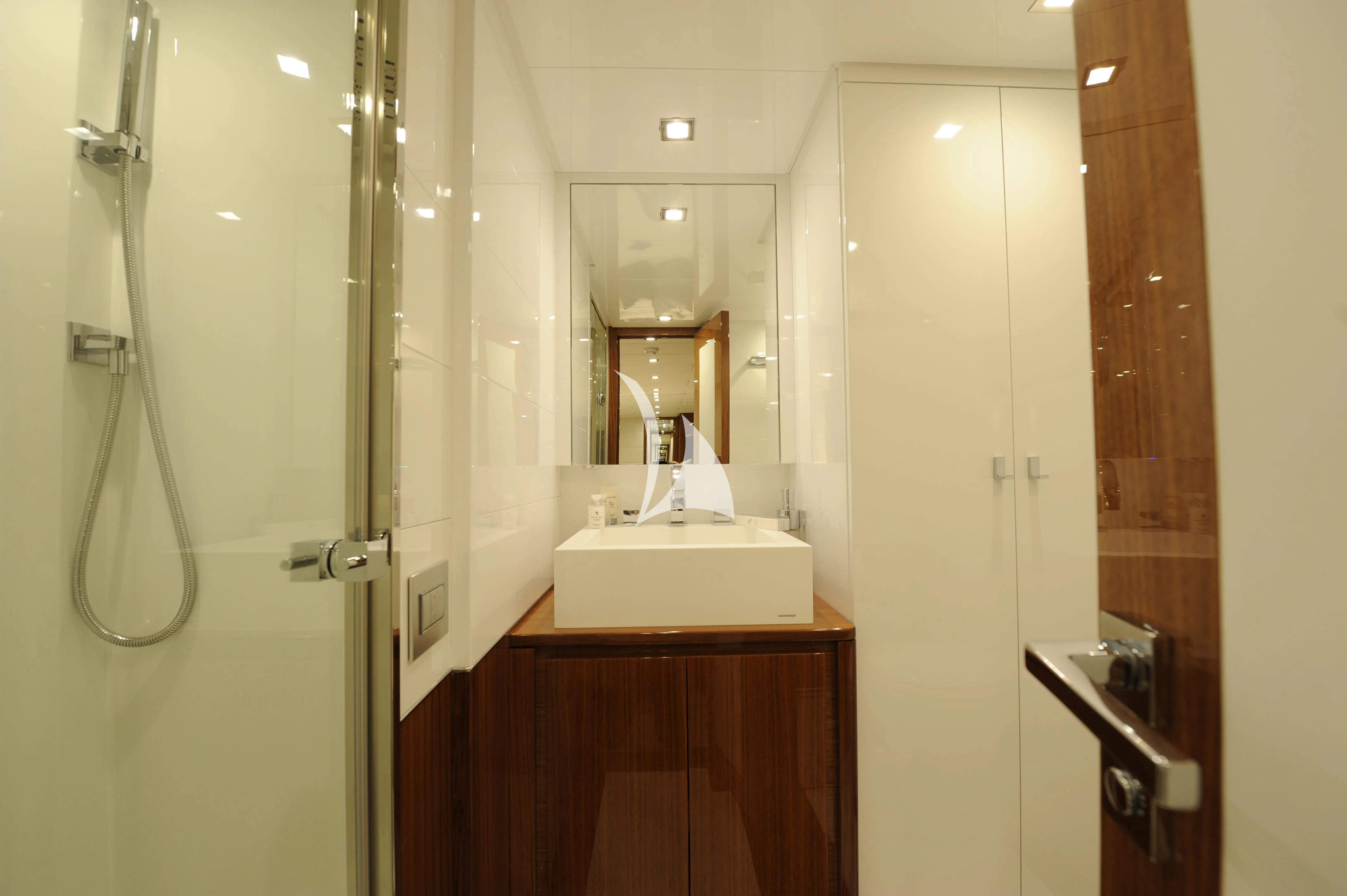a bathroom with a sink and a mirror aboard PHOENICIAN Yacht for Sale