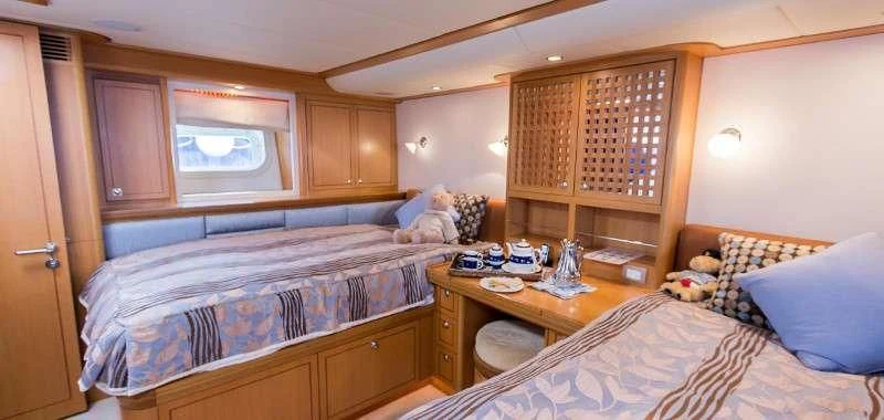 a bedroom with a bed and a desk aboard MARGARET ANN Yacht for Sale