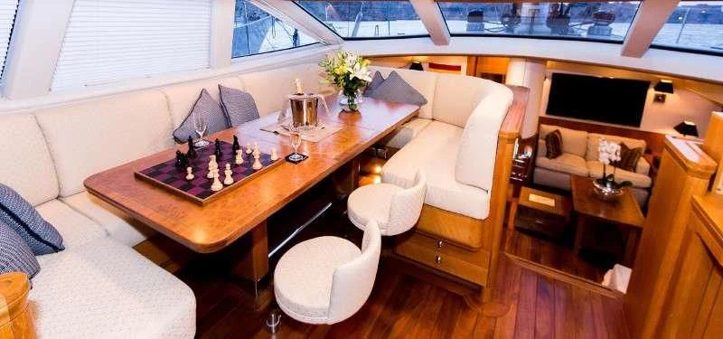 a living room with a table and couches aboard MARGARET ANN Yacht for Sale
