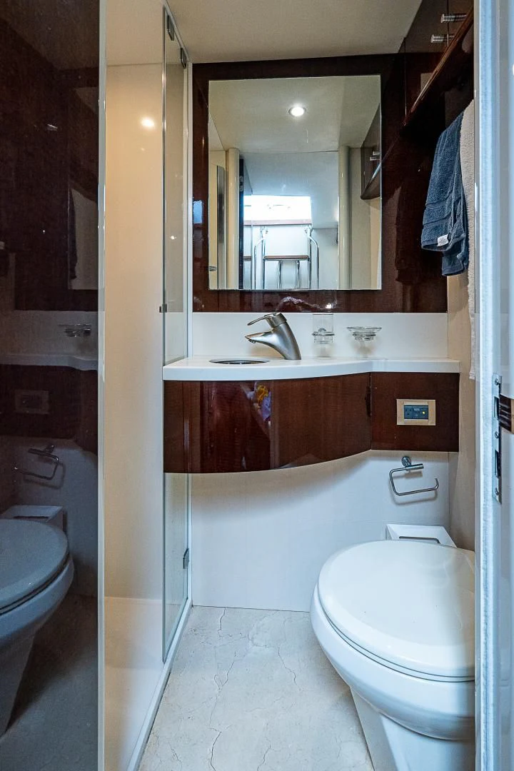 a bathroom with a toilet and a sink aboard LATITUDE Yacht for Sale