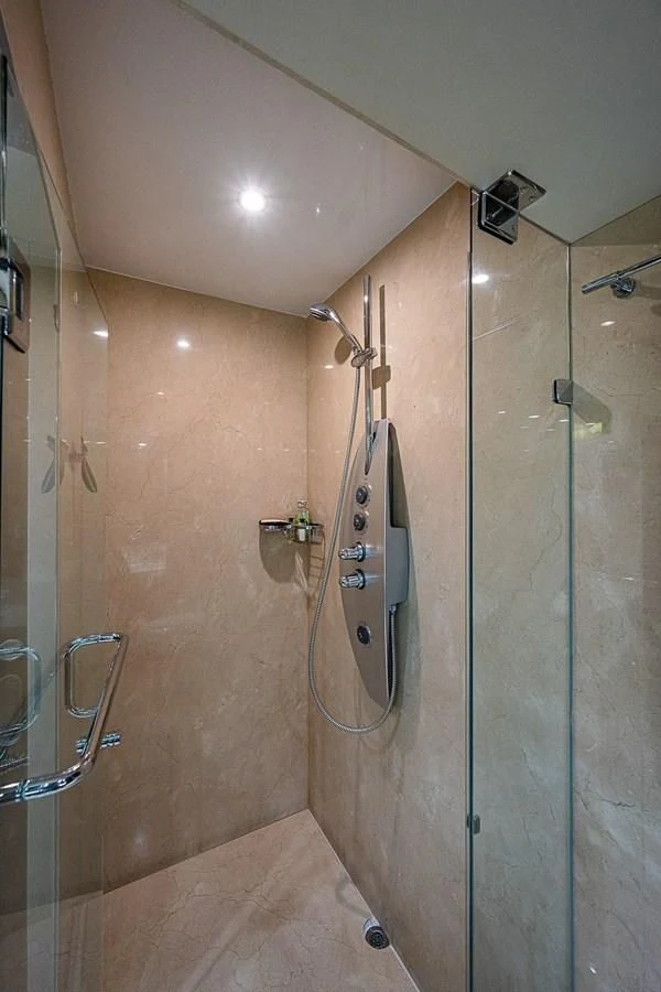 a bathroom with a shower unit aboard LATITUDE Yacht for Sale
