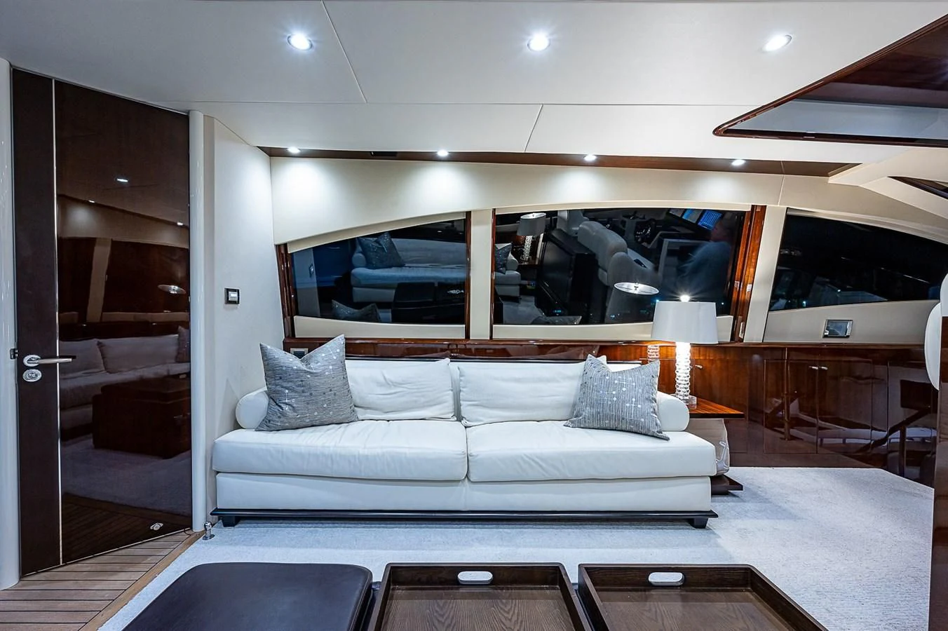 a living room with a couch and a large window aboard LATITUDE Yacht for Sale