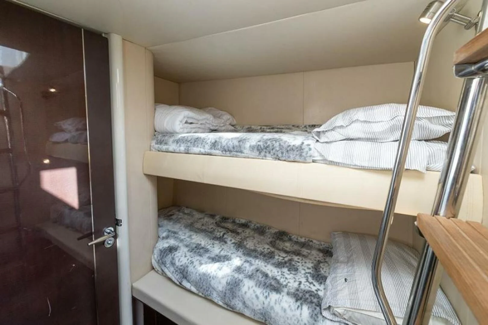 a bed with white sheets aboard LATITUDE Yacht for Sale