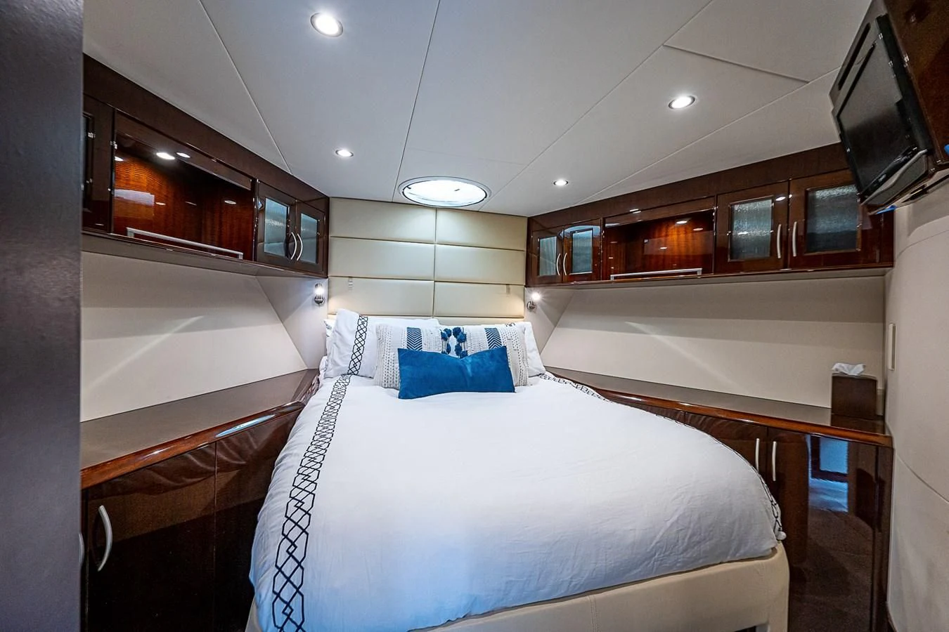 a room with a bed and a television aboard LATITUDE Yacht for Sale