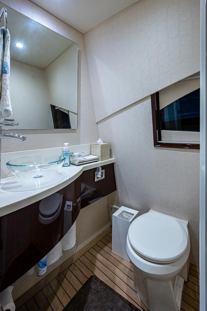 a bathroom with a sink toilet and a mirror aboard LATITUDE Yacht for Sale