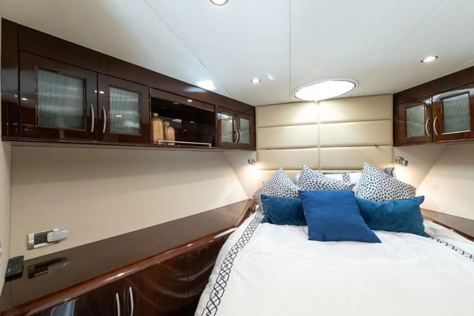 a modern looking bedroom with a large bed and cabinets aboard LATITUDE Yacht for Sale