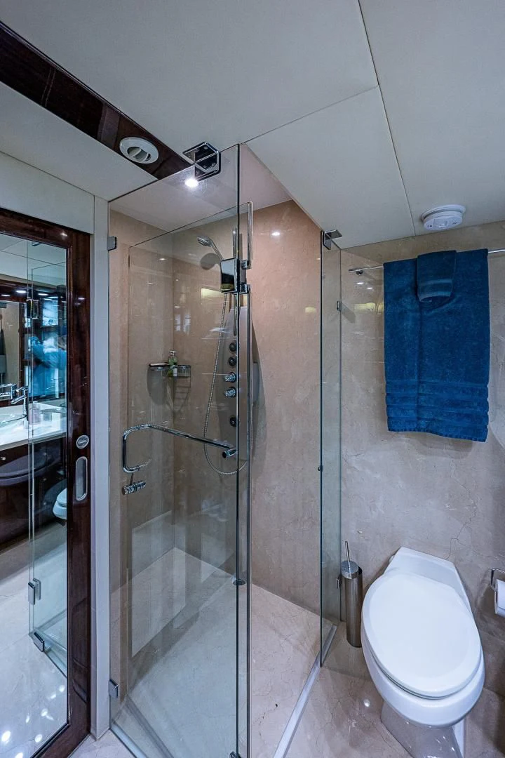 a bathroom with a glass shower aboard LATITUDE Yacht for Sale