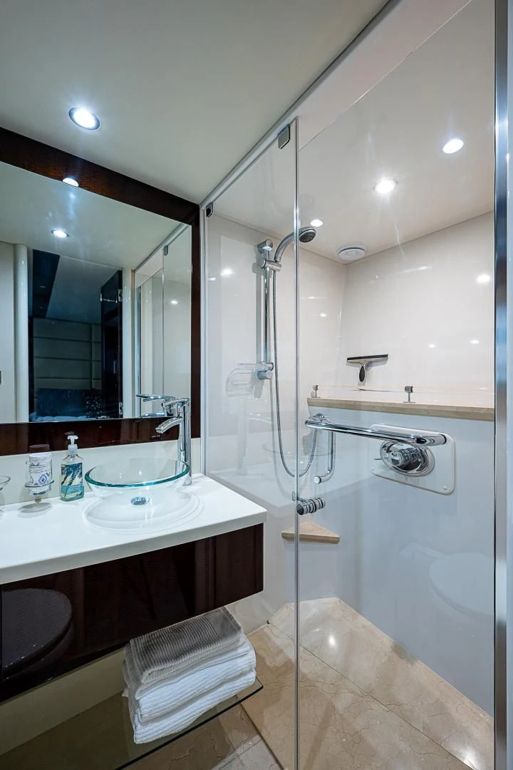 a bathroom with a shower unit and sink aboard LATITUDE Yacht for Sale