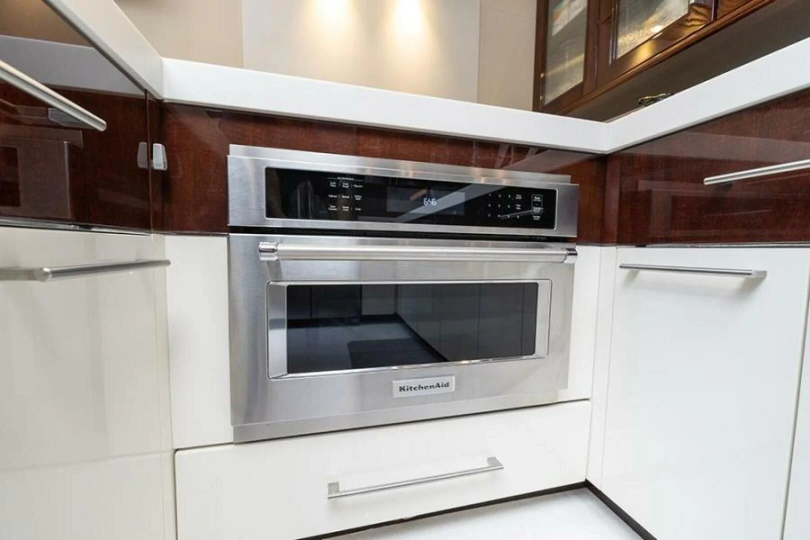 a white kitchen with a microwave oven aboard LATITUDE Yacht for Sale