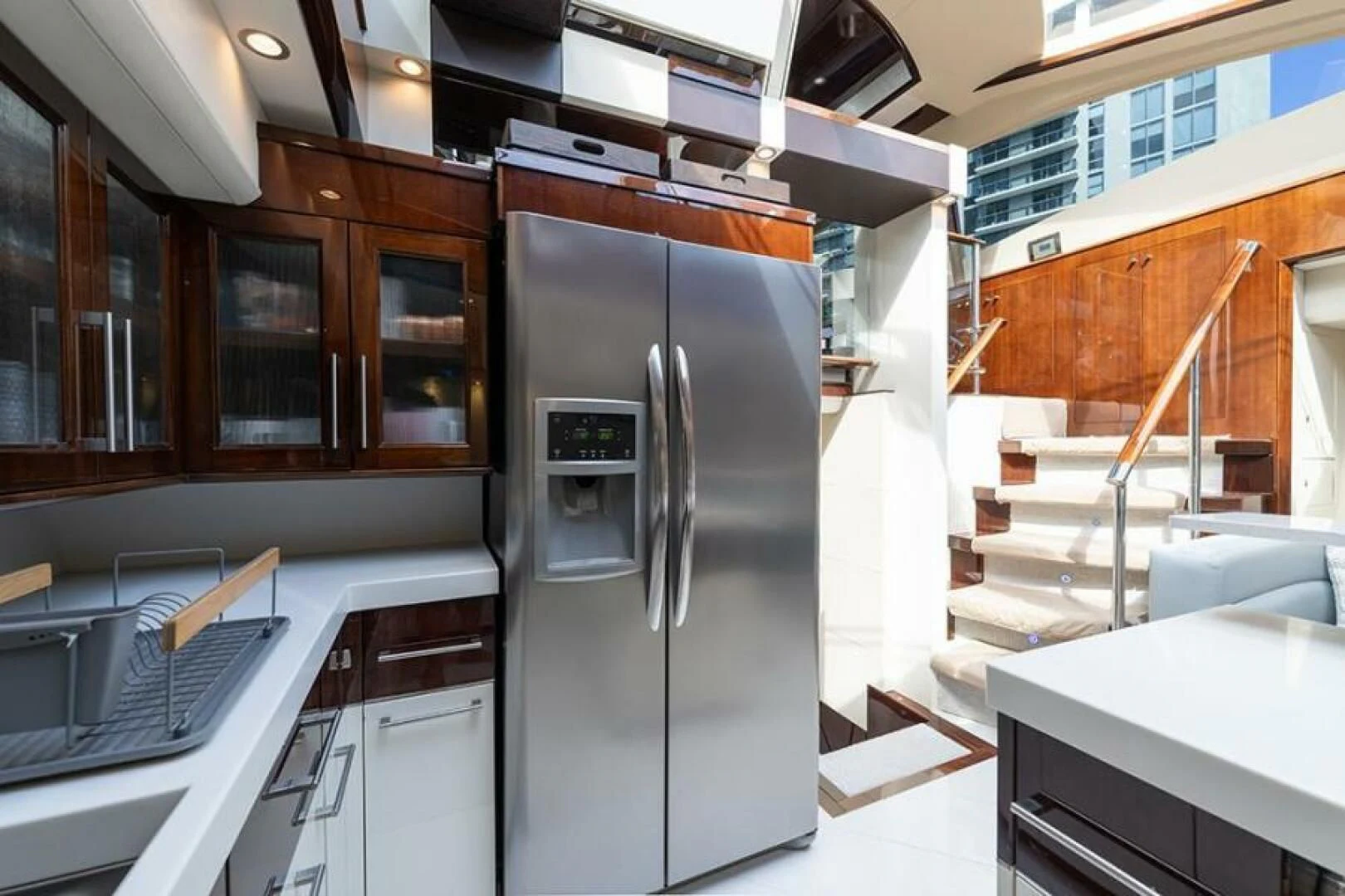 a kitchen with a refrigerator and a staircase aboard LATITUDE Yacht for Sale