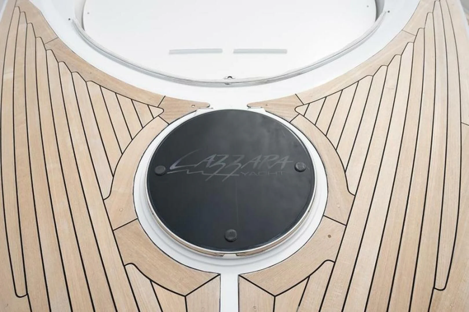 a black circular object on a wooden surface aboard LATITUDE Yacht for Sale