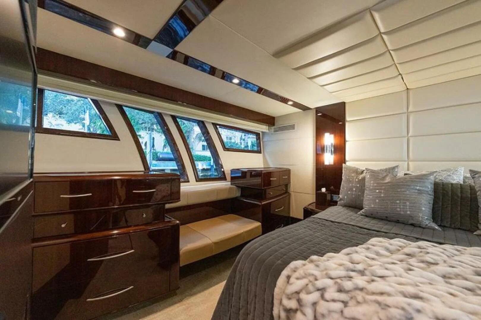 a bedroom with a bed and a dresser aboard LATITUDE Yacht for Sale