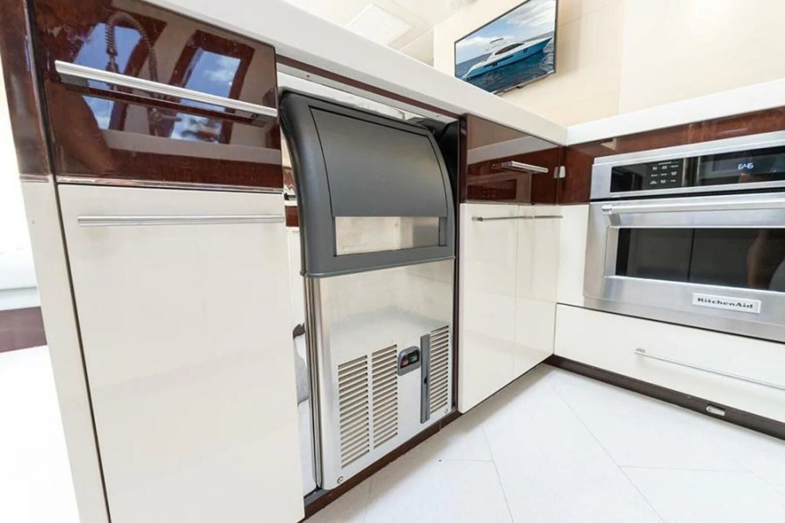 a kitchen with white cabinets aboard LATITUDE Yacht for Sale