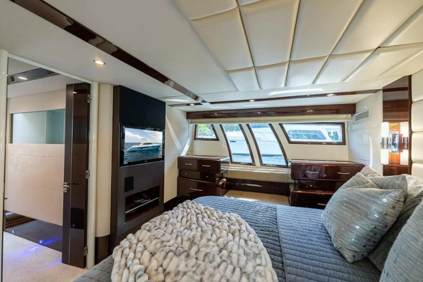 a bedroom with a bed and a tv aboard LATITUDE Yacht for Sale