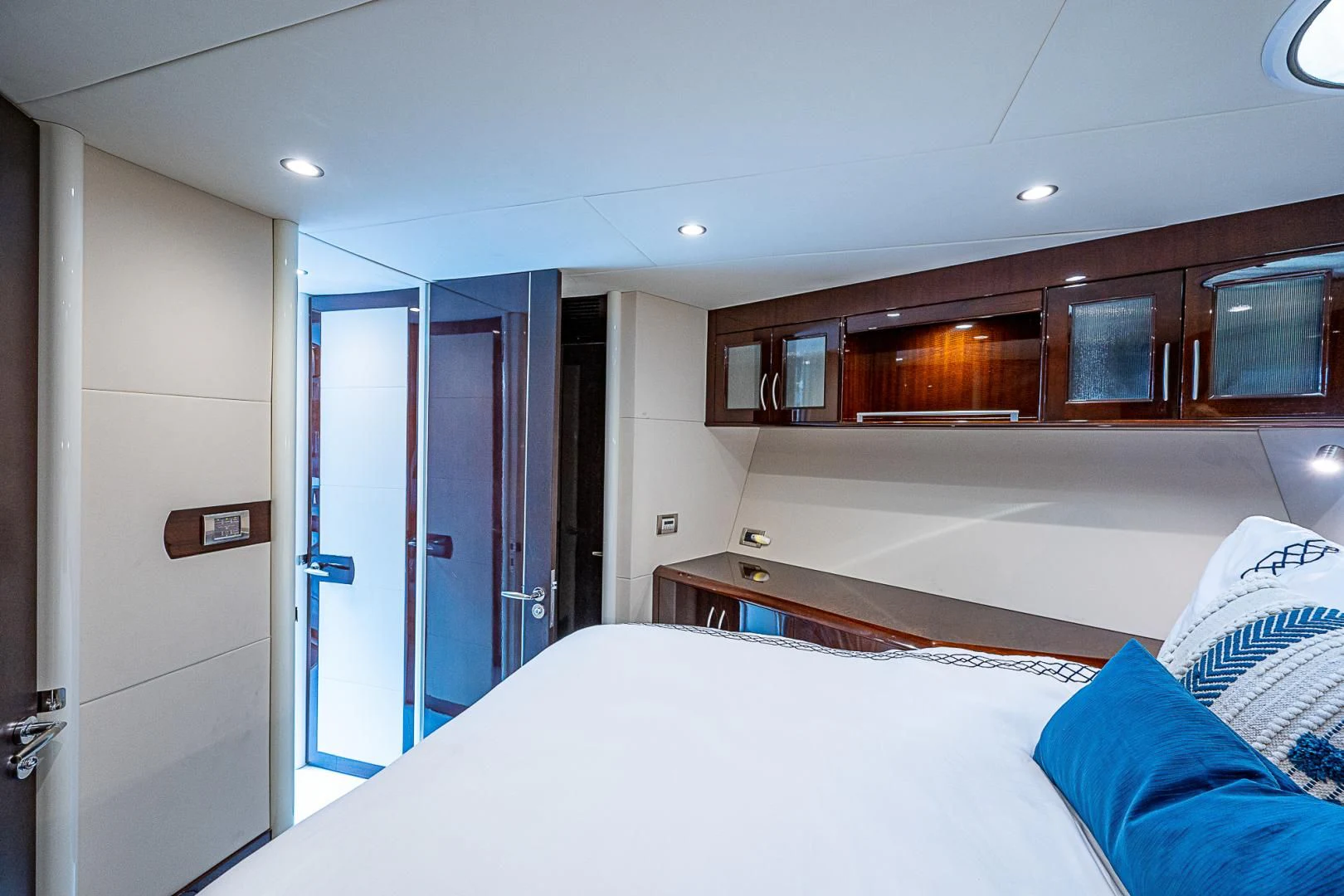 a bedroom with a bed and cabinets aboard LATITUDE Yacht for Sale