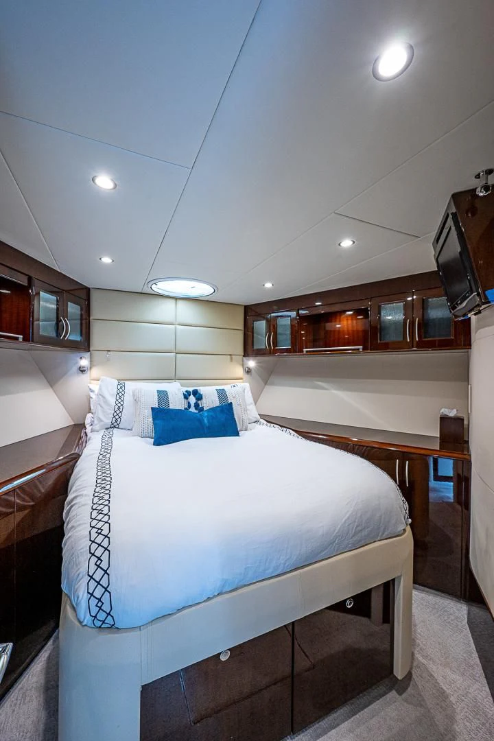 a room with a bed and a mirror aboard LATITUDE Yacht for Sale