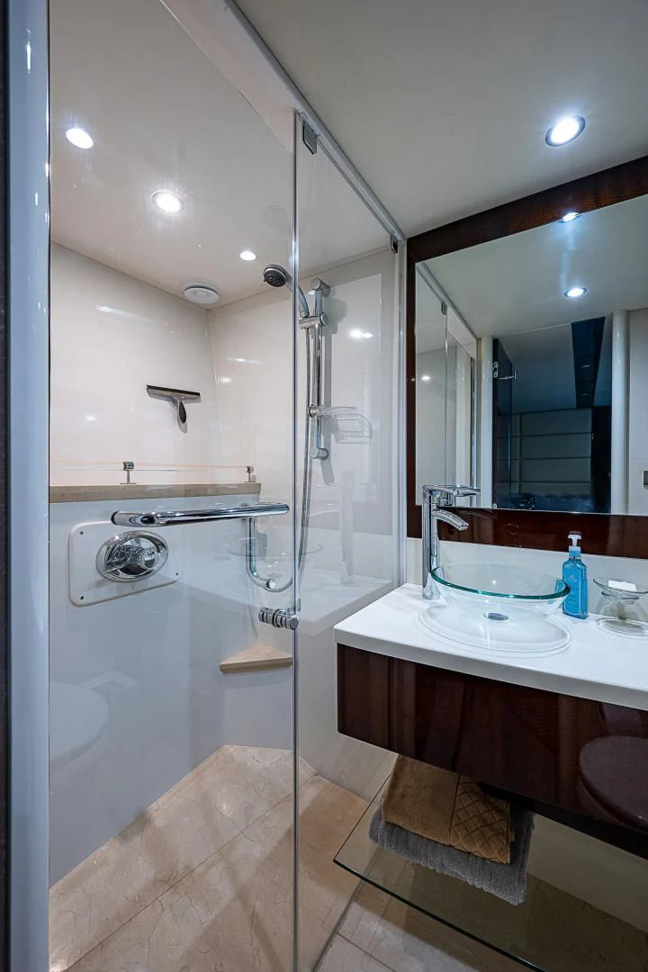 a bathroom with a glass shower aboard LATITUDE Yacht for Sale