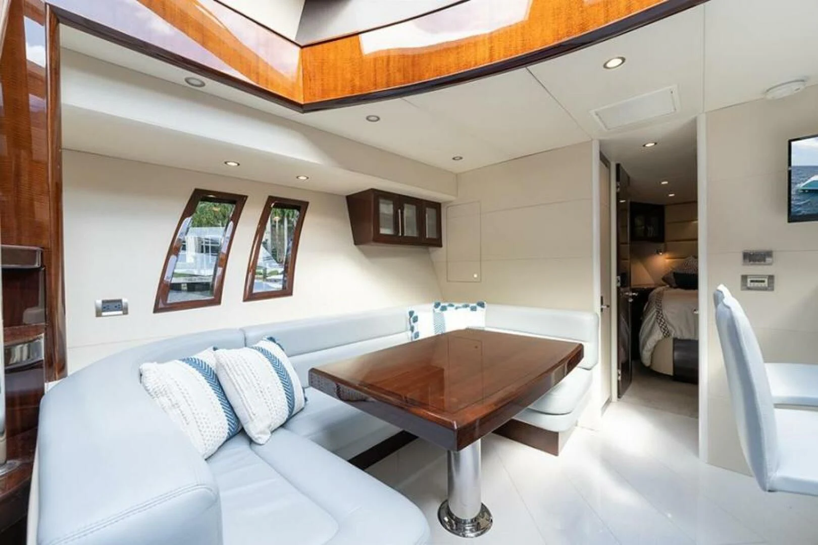 a room with a table and a couch aboard LATITUDE Yacht for Sale