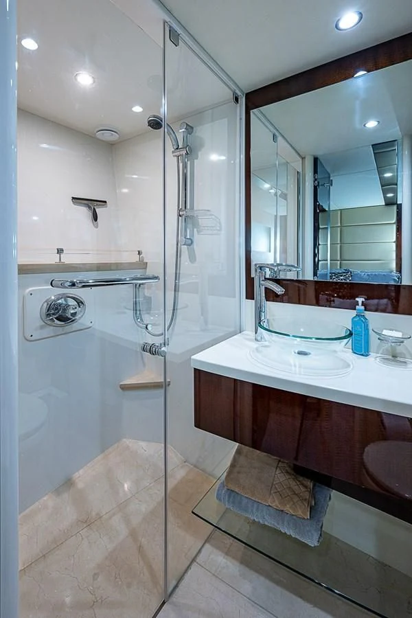 a bathroom with a glass shower aboard LATITUDE Yacht for Sale
