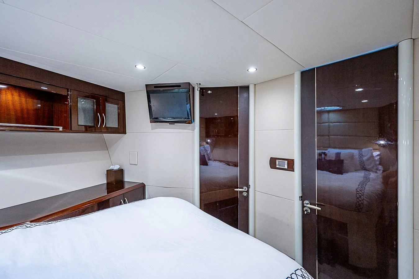 a bedroom with a bed and a television aboard LATITUDE Yacht for Sale