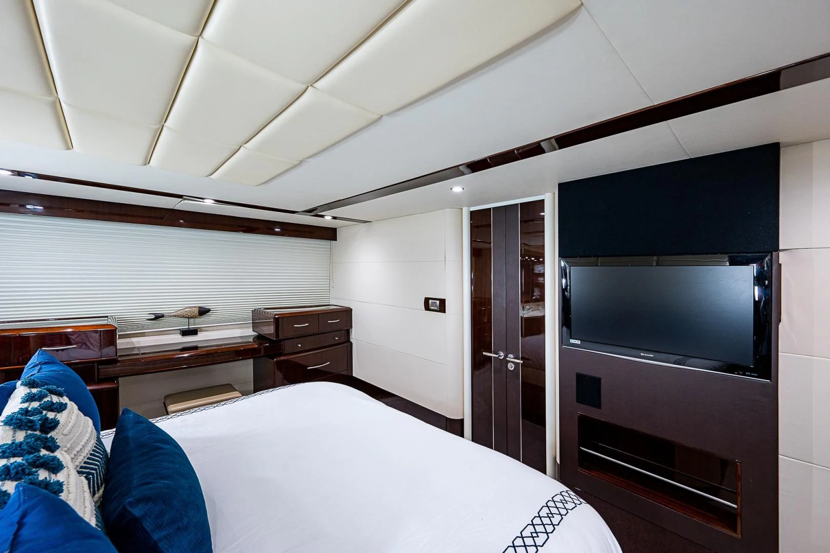 a room with a bed and a television aboard LATITUDE Yacht for Sale