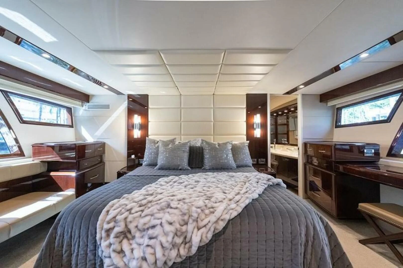 a bedroom with a bed and desk aboard LATITUDE Yacht for Sale