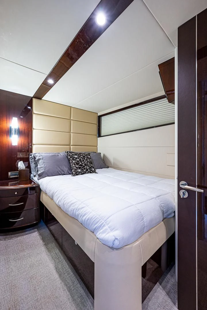 a bed with a white comforter aboard LATITUDE Yacht for Sale