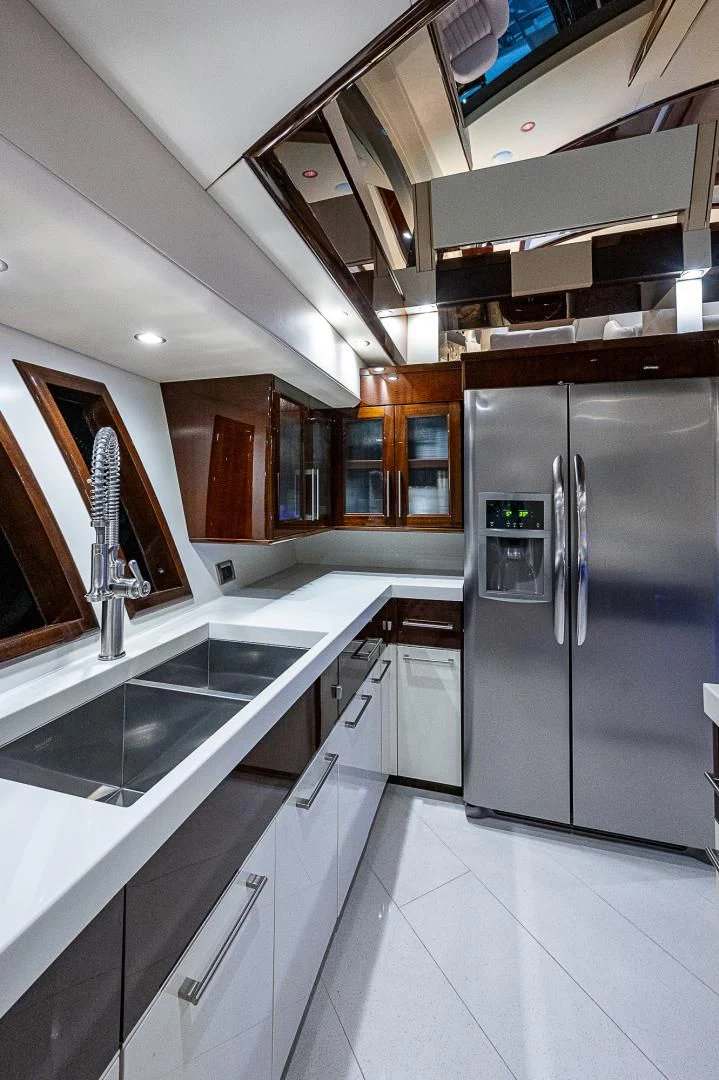 a kitchen with a stainless steel refrigerator aboard LATITUDE Yacht for Sale