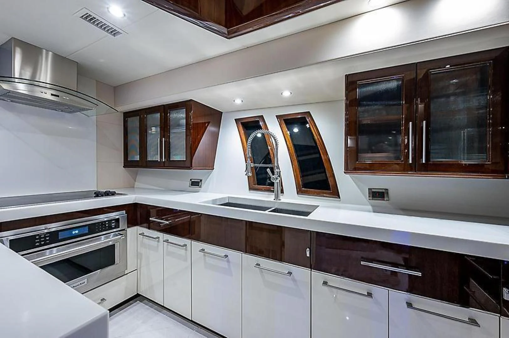 a kitchen with white cabinets aboard LATITUDE Yacht for Sale