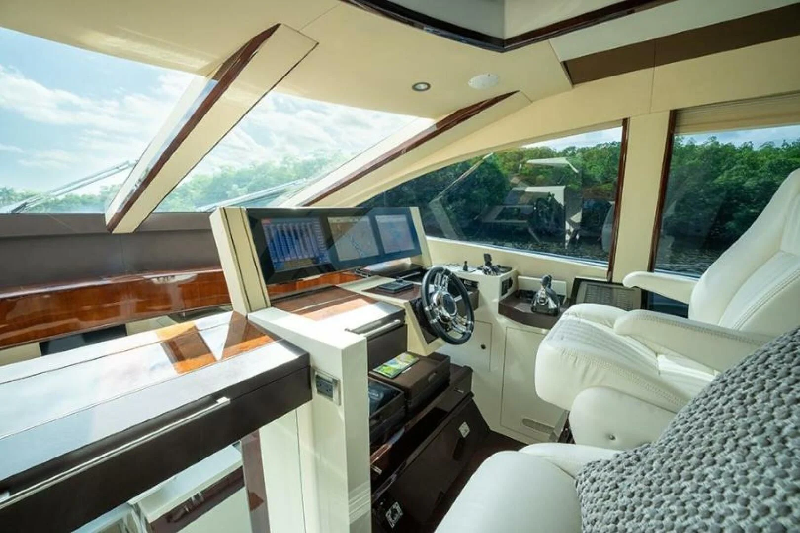 a room with a desk and a chair and a window with a view of the mountains aboard LATITUDE Yacht for Sale