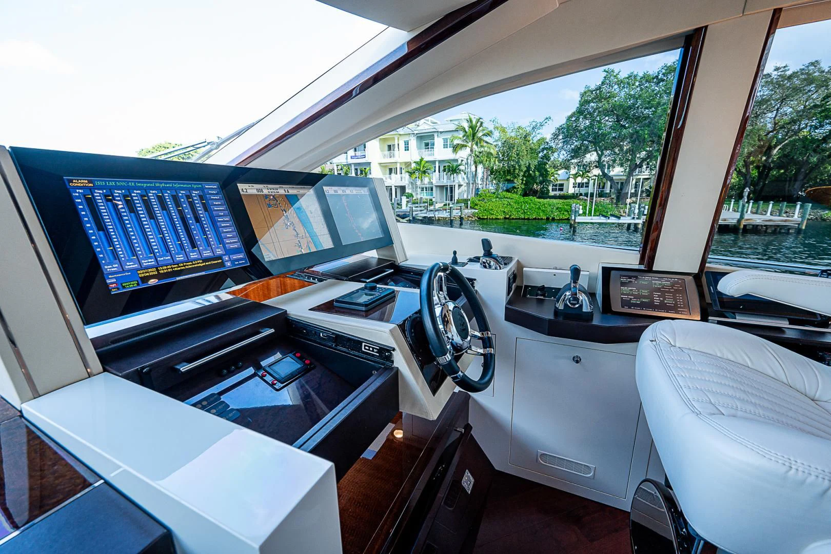 a room with a large window and a desk with computers on it aboard LATITUDE Yacht for Sale