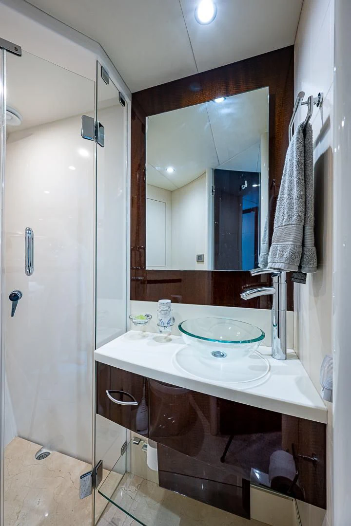 a bathroom with a sink and a mirror aboard LATITUDE Yacht for Sale