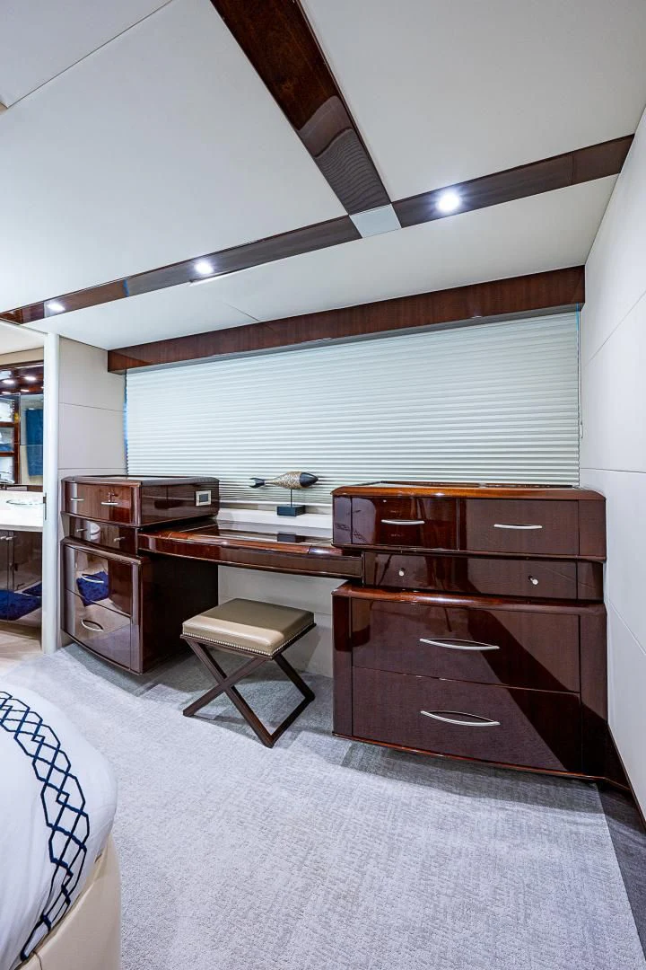 a room with a desk and a bed aboard LATITUDE Yacht for Sale