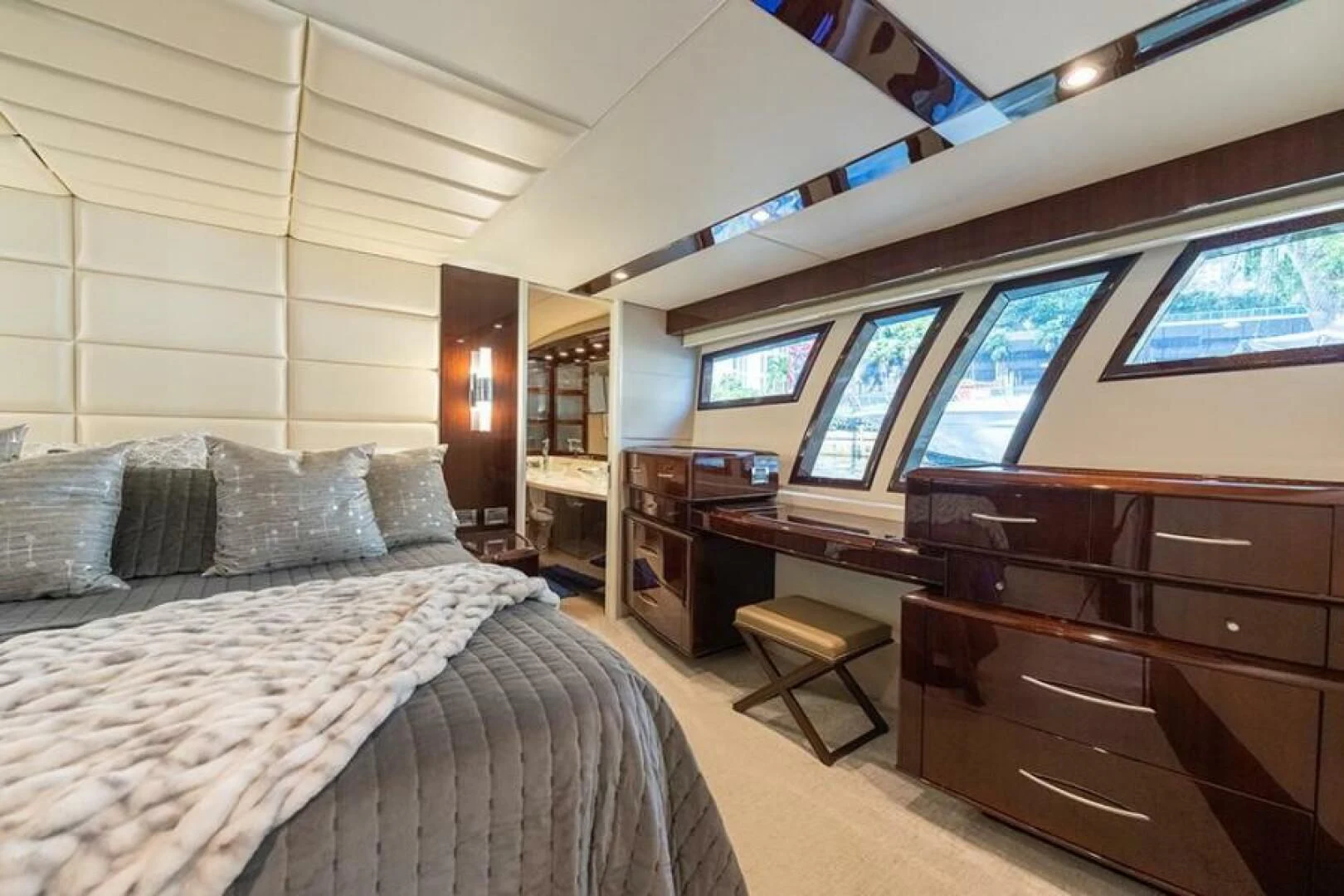 a bedroom with a bed and a desk aboard LATITUDE Yacht for Sale