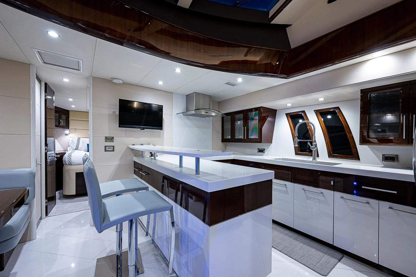 a large kitchen with a bar and a bar aboard LATITUDE Yacht for Sale