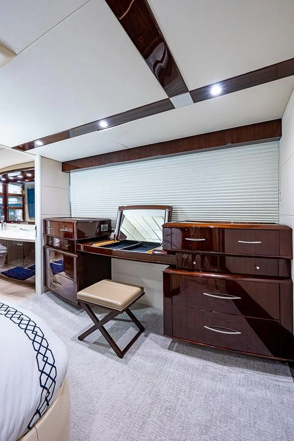 a room with a desk and a bed aboard LATITUDE Yacht for Sale