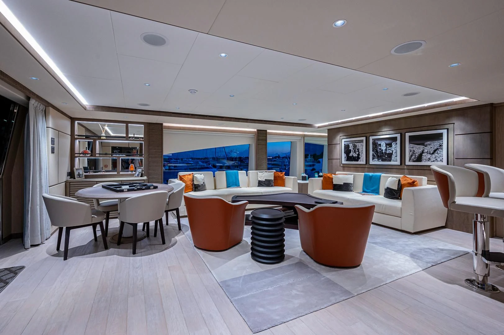 a room with a table chairs and a couch aboard LIRA Yacht for Sale