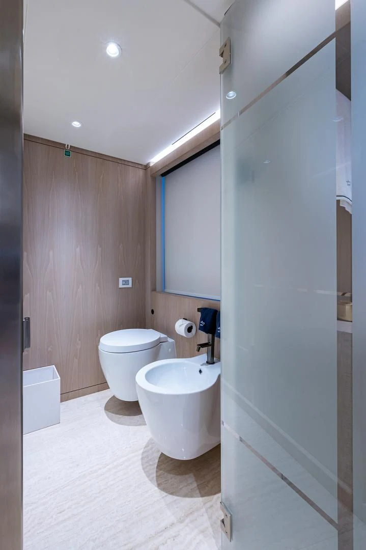 a bathroom with a toilet and sink aboard LIRA Yacht for Sale