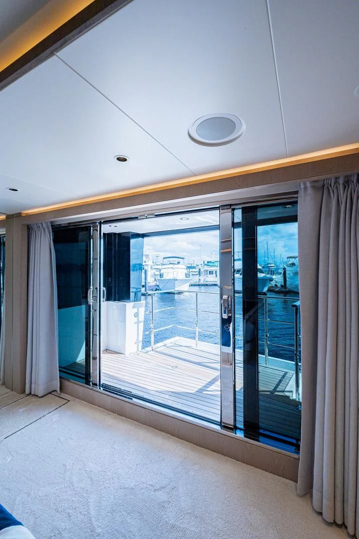 a glass door with a view of a city aboard LIRA Yacht for Sale