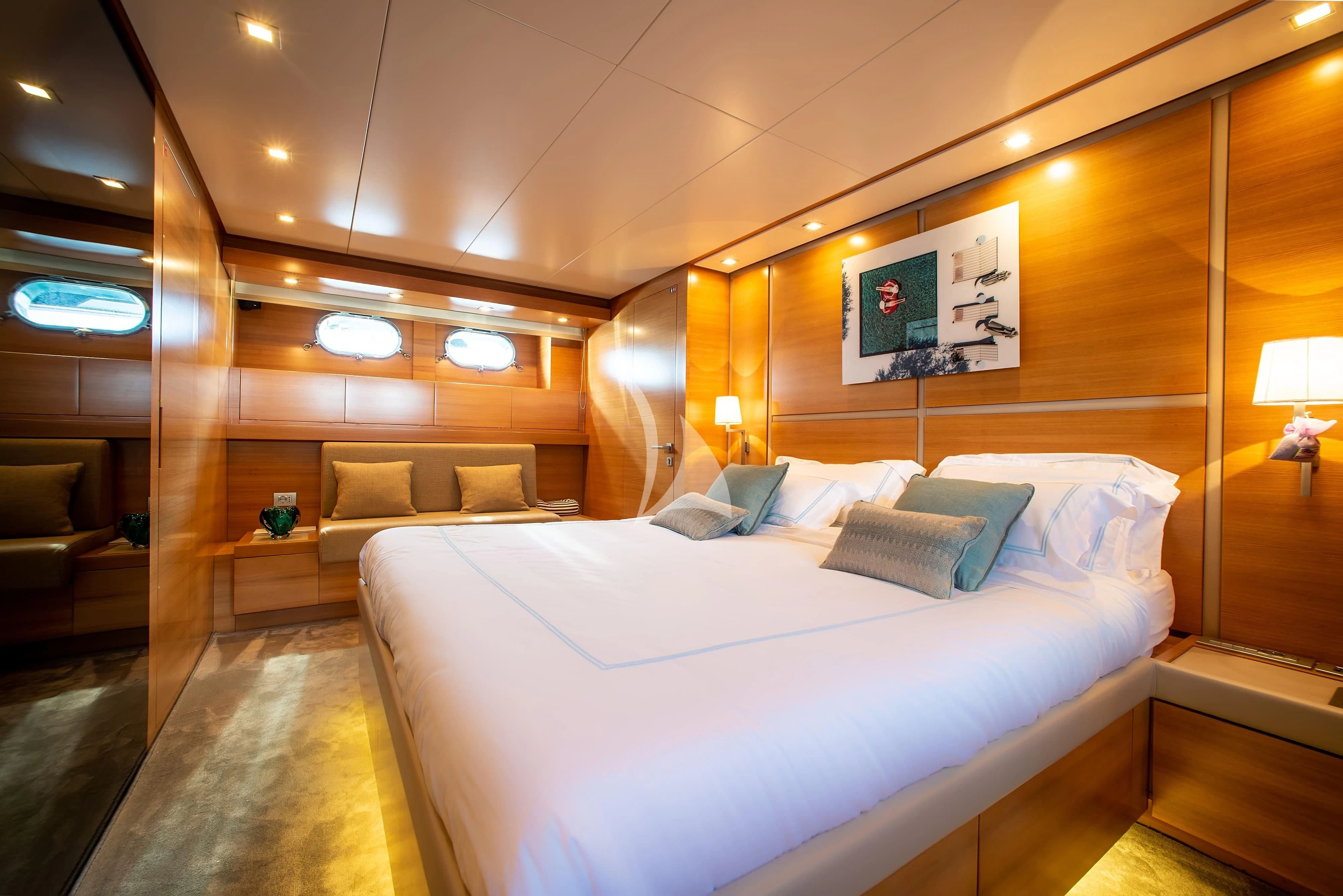 a room with a bed and a couch aboard PERTULA Yacht for Sale