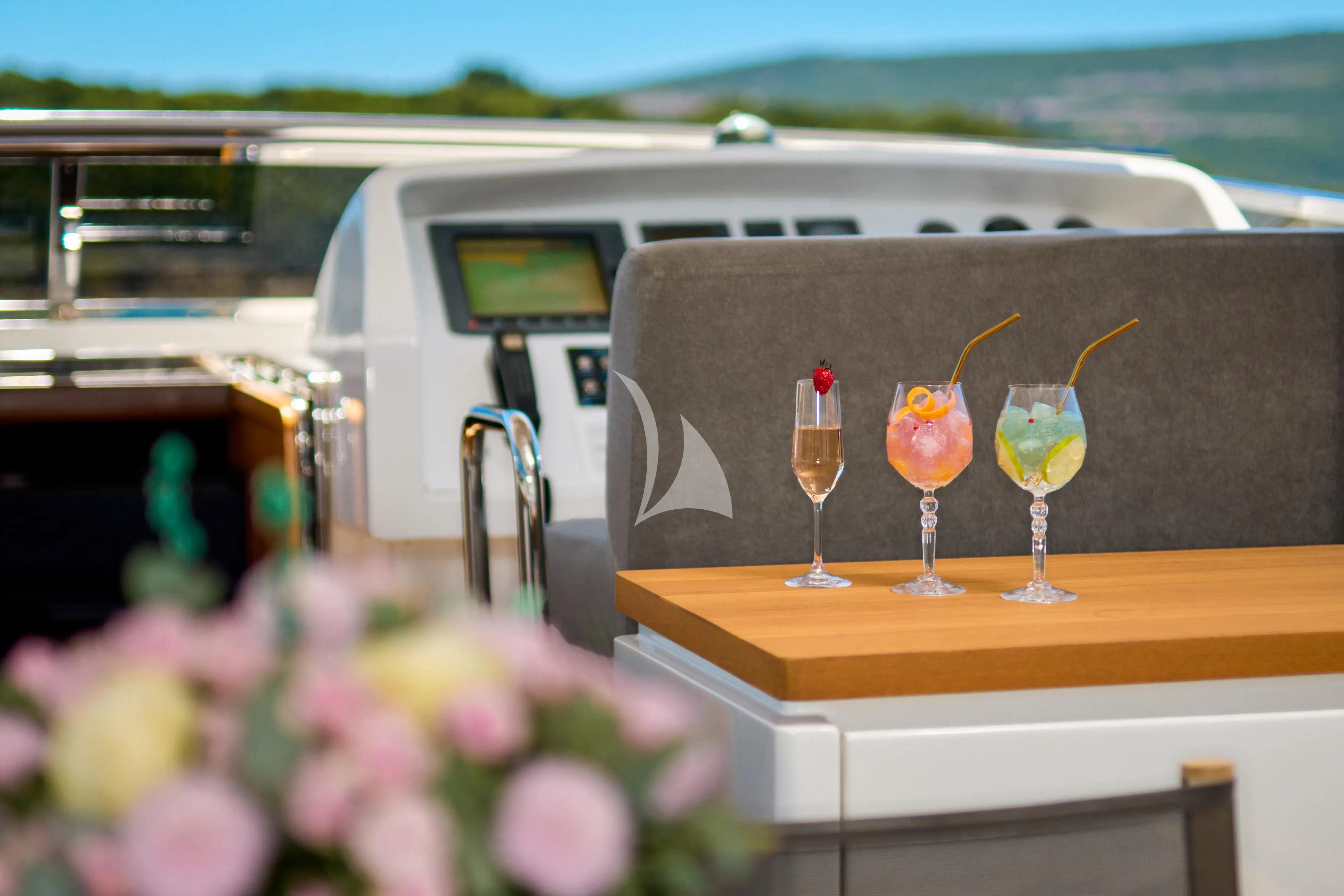 a group of glasses with drinks in them on a table aboard PERTULA Yacht for Sale