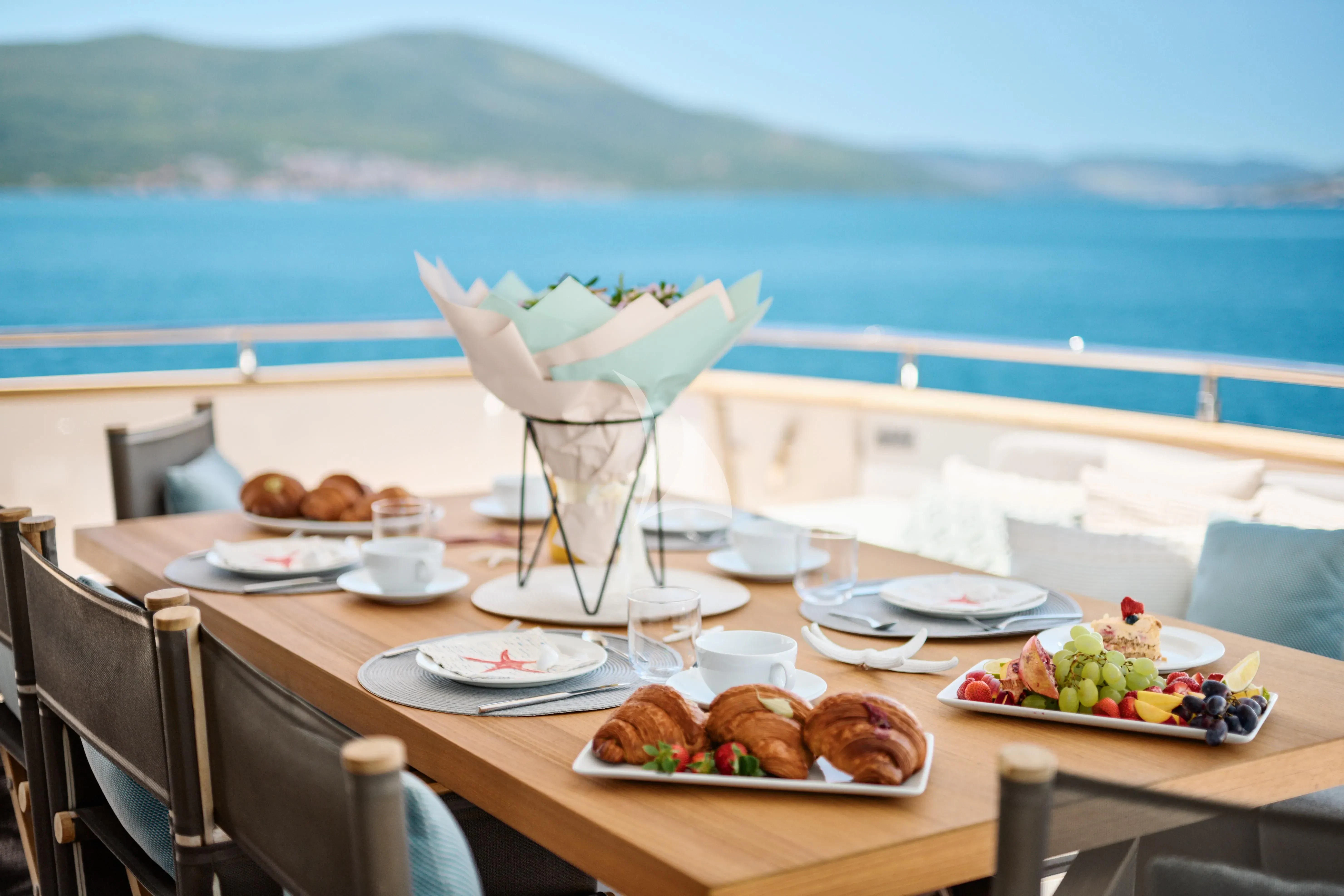 a table with food on it aboard PERTULA Yacht for Sale