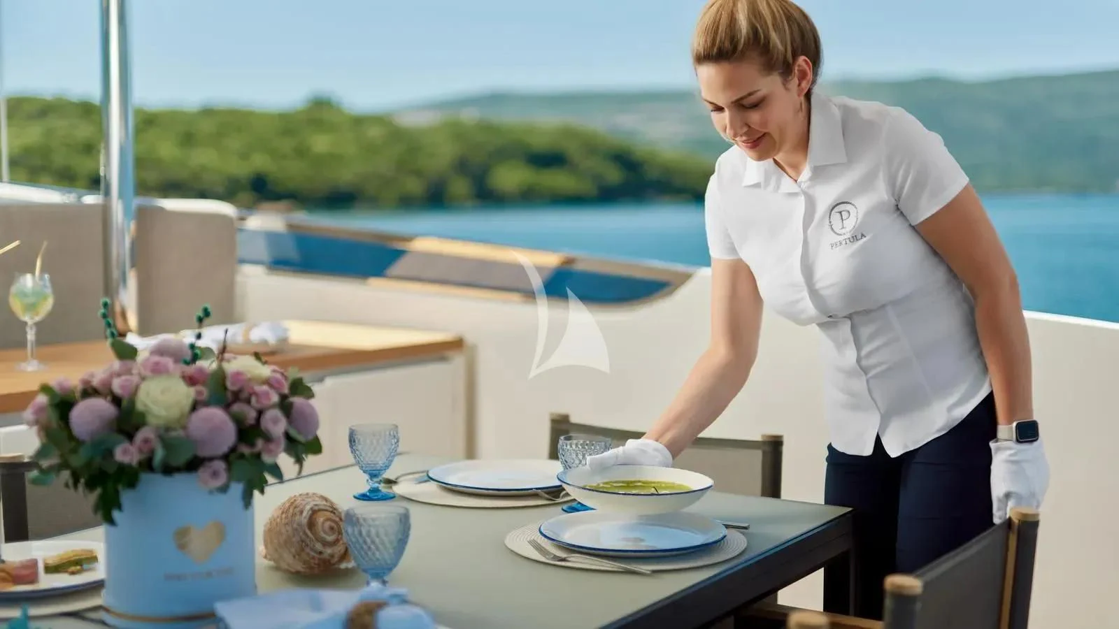 a woman in a white shirt aboard PERTULA Yacht for Sale